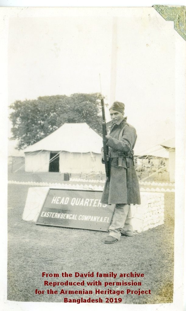 Eastern Bengal Coy Headquarters tent. Ruben David posing with his rifle.